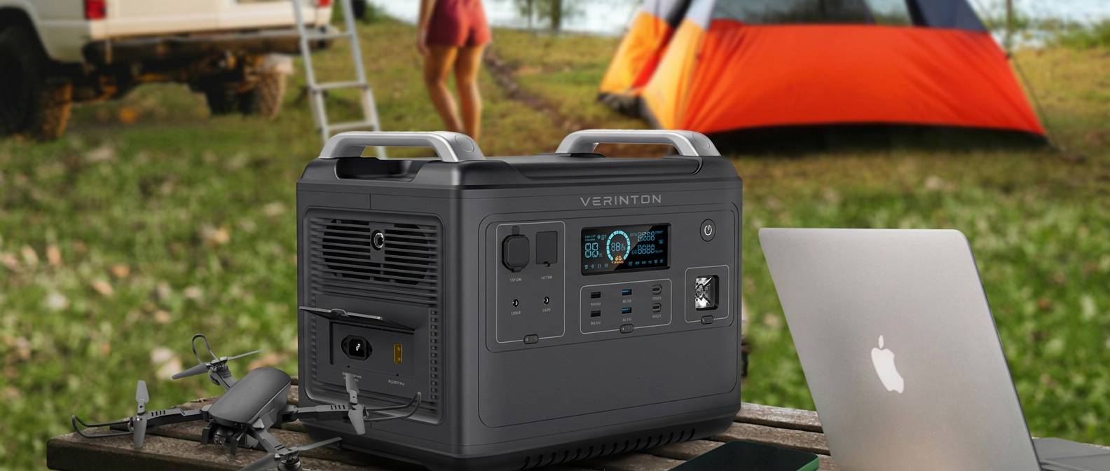 VERINTON Apex 2400 Pro on a picnic table at a lakeside campsite powering a laptop and a drone